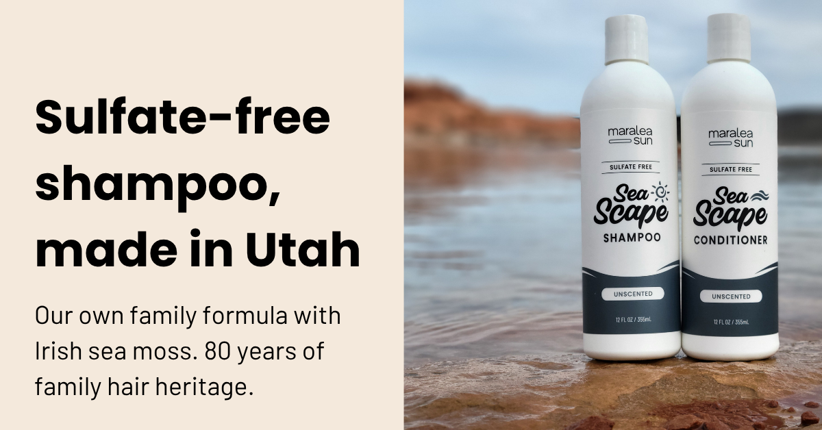 Maralea Sun Sea Scape sulfate-free shampoo and conditioner, made in Utah, on the rocks at the water with red rock cliffs behind